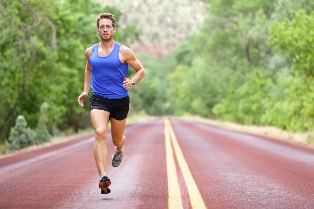 Man running along a highway