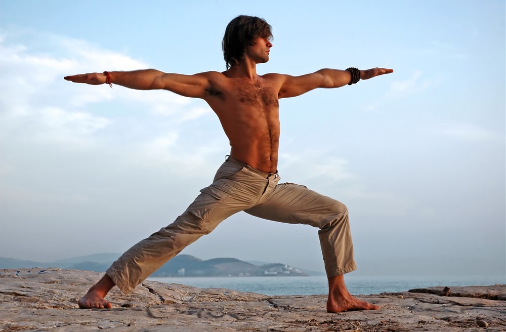 Man performing a yoga pose - warrior II